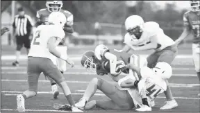  ?? HERALD Photo/Shawn Moran ?? A Coahoma ball-carrier is taken down hard by an Idalou defender during Thursday night’s loss.