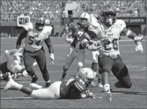  ?? The Associated Press ?? MONEY RUN: Troy running back B.J. Smith (26) runs into the end zone past Nebraska defensive lineman Khalil Davis (94) during the first half of the Trojans’ 24-19 win Saturday in Lincoln, Neb.