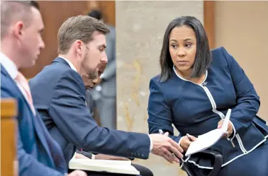  ?? AP PHOTO/BEN GRAY ?? Fulton County District Attorney Fani Willis, right, talks with a member of her team during proceeding­s to seat a special purpose grand jury in Fulton County, Ga., on May 2 to look into the actions of former President Donald Trump and his supporters who tried to overturn the results of the 2020 election.
