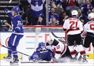  ?? FRANK GUNN, THE CANADIAN PRESS ?? Leafs’ William Nylander, left, celebrates his goal as teammate Auston Matthews and New Jersey defender Ben Lovejoy (12) battle on the ice and Devils’ Kyle Palmieri and Andy Greene look on. Toronto won, 4-2.