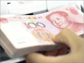  ?? PHOTO: BLOOMBERG ?? Chinese yuan banknotes are fed into a money counting machine in Seoul, South Korea.