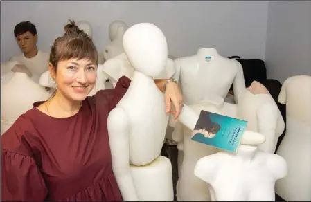  ?? (Arkansas Democrat-Gazette/Cary Jenkins) ?? Writer Jen Fawkes poses with mannequins at the Old State House Museum. The Little Rock author has a new book of short stories, “Mannequin and Wife.”