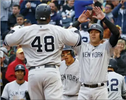  ?? GENE J. PUSKAR — THE ASSOCIATED PRESS ?? The Yankees’ Chris Carter (48) celebrates with Austin Romine, right, after hitting a home run in the eighth inning on Saturday.