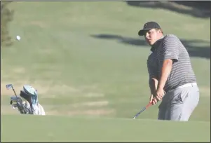  ?? The Sentinel-Record/Richard Rasmussen ?? MOVING OUT: Harding sophomore Ryan Camras, a Lakeside graduate, chips onto the 13th green during the first round of the Great American Conference Men’s Golf Championsh­ip at Hot Springs Country Club on April 15. The GAC announced Wednesday that the tournament will not be held in Hot Springs for the 2020 season, but it may return in 2021.