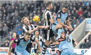 ??  ?? Newcastle goalscorer Daryl Murphy goes for a header as United press.