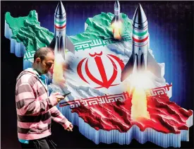  ?? Picture: Atta Kenare /AFP ?? A banner displayed in central Tehran yesterday