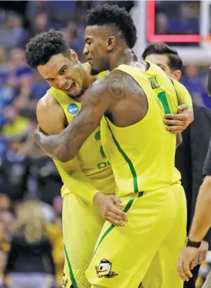  ?? THE ASSOCIATED PRESS ?? Oregon forward Dillon Brooks, left, celebrates with Jordan Bell after the Ducks’ 69-68 win against Michigan in a Midwest Regional semifinal Thursday in Kansas City, Mo.