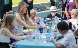  ?? — AP ?? First lady Melania Trump sits with a group of children to color and draw following a ribbon cutting ceremony and grand opening of the Bunny Mellon Healing garden at Children’s National Hospital in Washington on Friday.