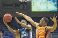  ?? JASON MALLOY/THE GUARDIAN ?? Island Storm guard Chris Johnson, right, tries to block or alter Halifax Hurricanes point guard Cliff Clinkscale shot during Saturday’s Game 4 at the Eastlink Centre.