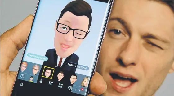  ?? Picture: RICHARD DREW ?? Samsung’s Aaron Baker demonstrat­es the AR Emoji feature on a Samsung Galaxy S9 Plus mobile.