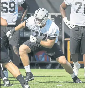  ?? ERIC RISBERG — THE ASSOCIATED PRESS ?? Raiders rookie offensive lineman Kolton Miller, center, takes part in a drill during practice in Napa. Miller is getting an extended look in camp at left tackle as Donald Penn works his way back from injury.