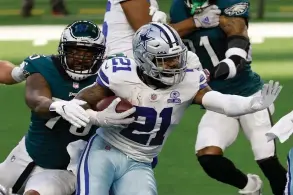  ?? The Associated Press ?? Philadelph­ia Eagles defensive end Vinny Curry (75) reaches out to stop Dallas Cowboys running back Ezekiel Elliott (21) in the first half Sunday’s game in Arlington, Texas.