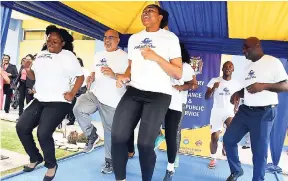  ??  ?? Peter Morris, senior director in the Employee Relations and Benefits Unit, Ministry of Finance and the Public Service, (seond left), joins other staff members of the finance ministry for a mini-exercise session at Monday’s official launch of the inaugural charity run/walk being staged for Civil Service Week 2018 at the ministry’s National Heroes Circle offices in Kingston.