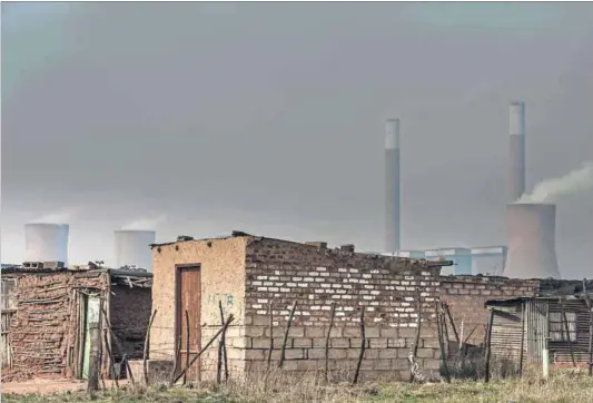  ?? Photo: Mujahid Safodien/AFP ?? Health hazard: People living in houses near the coal-fired Duvha power plant on the outskirts of Witbank breathe polluted air.