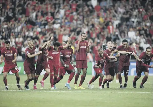  ??  ?? 0 The Liverpool squad react as Adrian saves Tammy Abraham’s penalty to win the Super Cup for Jurgen Klopp’s side.