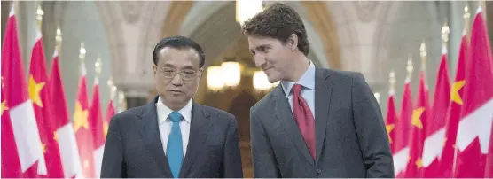  ?? ADRIAN WYLD/THE CANADIAN PRESS ?? Prime Minister Justin Trudeau speaks with Chinese Premier Li Keqiang at a signing ceremony and news conference in Ottawa Thursday.