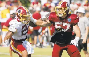  ?? MARK GORMUS/RICHMOND TIMES-DISPATCH ?? Kutztown University product Craig Reynolds, left, is in training camp with the Washington Redskins. He rushed for 21 yards in the team’s first preseason game.