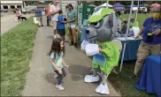  ??  ?? Della Mercer, 5, dances with Rocky the Recycling Dog from Paw Patrol, during Saturday’s Pet Fair.