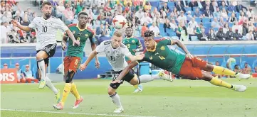  ??  ?? Cameroon’s Adolphe Teikeu (ringt) in action with Germany’s Joshua Kimmich during the FIFA Confederat­ions Cup group B football at the Fisht Stadium Stadium. — Reuters photo