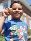  ??  ?? Ryan Itahi, 4, one of the youngest campers, with his "favourite" ball.