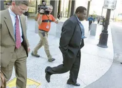  ?? PHIL VELASQUEZ/CHICAGO TRIBUNE ?? Former Chicago police Sgt. Ronald Watts, right, leaves the Dirksen U.S. Courthouse after being sentenced on Oct. 9, 2013.