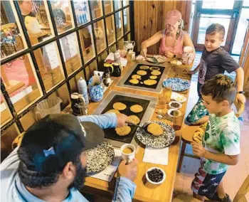  ?? PATRICK CONNOLLY/ORLANDO SENTINEL ?? The Sanford-based Sanchez family, from left, Alex, Lauren, Dominick, 8, and Luca, 6, enjoy a meal at the Old Spanish Sugar Mill restaurant in De Leon Springs State Park on Aug. 9.