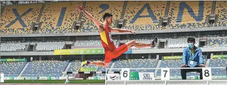  ?? PROVIDED TO CHINA DAILY ?? Long jumper Gaoxing Long leaps at full stretch during last month’s track-and-field test event for China’s 14th National Games at the newly built Xi’an Olympic Sports Center.