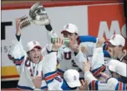  ?? PAUL CHIASSON — THE CANADIAN PRESS VIA AP ?? United States forward Luke Kunin (9) lifts the trophy as he and his teammates celebrate their victory over Canada in the gold medal game of the world junior hockey tournament in Montreal on Jan. 5.