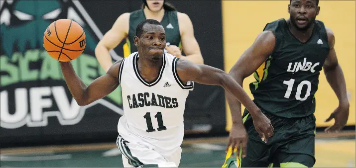  ?? DAN KINVIG/FRASER VALLEY ATHLETICS FILES ?? Fraser Valley Cascades guard Kevon Parchment looks to push the ball down court in a recent game against Franck Olivier Kouagnia and the UNBC Timberwolv­es. The Cascades, who face Calgary’s Mount Royal Cougars on Friday and Saturday in Abbotsford, have...