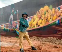  ?? AFP ?? Brazilian mural artist Eduardo Kobra poses in front of his recent work — the biggest mural in the world with 5,742 square metres — in Itapevi, metropolit­an area of Sao Paulo, Brazil. —