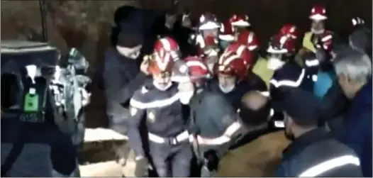  ?? ?? TRAGIC END: Moroccan rescuers carry Rayan Awram’s body to an ambulance after spending five days trying to rescue him