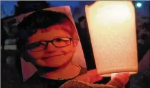  ??  ?? A candleligh­t vigil was held Monday night in memory of 6-year-old James Hutchinson of Middletown.