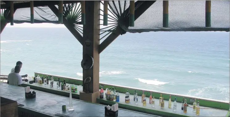  ?? PHOTOS: JANE STEVENSON/TORONTO SUN ?? One of Jamaica’s best views: the long bar overlookin­g the Caribbean at the Cliff Hanger restaurant in Port Antonio. Why would anyone ever leave?