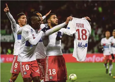  ?? AFP PIC ?? Lyon’s Nabil Fekir antagonise­s the home fans after scoring against Saint-Etienne which led to a pitch invasion on Sunday. Lyon won 5-0.