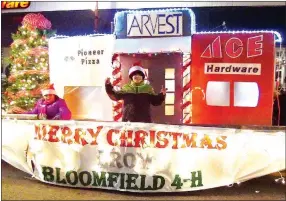  ?? Photo by Randy Moll ?? The float of Bloomfield 4-H depicted a number of Main Street businesses, along with a decorated Christmas tree, in the annual Gentry Chamber of Commerce Christmas Parade on Saturday.