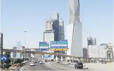  ??  ?? Cars drive past the King Abdullah Financial District in Riyadh, Saudi Arabia. Saudi Arabia’s King Salman announced recreation­al projects in the capital Riyadh worth US$23 billion, officials said, in a new drive to transform the congested city. — Reuters photo