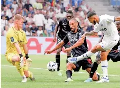  ?? ?? Marseille’s Colombian forward Luis Suarez (second right) kicks the ball as Reims’ Austrian goalkeeper Patrick Pentz (first left) goes to block it during the French L1 soccer match at the Stade Velodrome in Marseille, France on August 7, 2022.