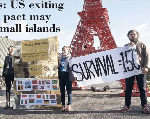  ?? AP ?? In this December 4, 2015 file photo, representa­tives of NGOs display a banner in front of a reproducti­on of the Eiffel Tower at the COP21, United Nations Climate Change Conference, in Le Bourget, north of Paris. To small island nations where the land...