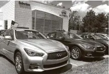  ?? Tom Krisher / Associated Press ?? Used Infiniti Q50 luxury sedans await buyers at a dealership in the Detroit suburb of Novi. Leases are ending on many Q50s and other cars, flooding the market with quality used cars.