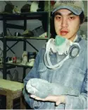  ??  ?? Wayne Puqiqnak holds a carving he completed at the Kitikmeot Carving Workshop, 1999