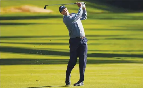  ?? (AFP) ?? Matt Kuchar of the United States plays a shot on the 13th hole during the first round of the Genesis Invitation­al in Pacific Palisades, California, on Thursday.