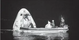  ?? BILL INGALLS / NASA ?? Support teams work around the SpaceX Crew Dragon Resilience spacecraft shortly after it landed with NASA astronauts Mike Hopkins, Shannon Walker, and Victor Glover, and Japan Aerospace Exploratio­n Agency (JAXA) astronaut Soichi Noguchi aboard in the Gulf of Mexico off the coast of Panama City, Fla., Sunday.