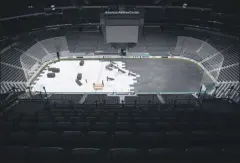  ?? ASHLEY LANDIS - THE ASSOCIATED PRESS ?? In this March 12, 2020, file photo, crews cover the ice at American Airlines Center in Dallas, home of the Dallas Stars hockey team, after the NHL season was put on hold due to the coronaviru­s.