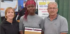  ??  ?? Lystus Ebosele (D.M.P.) is presented with her Athletics Wexford athlete of the month award by Marie Mooney of Mr Oil and Paddy Morgan, Chairman, Athletics Wexford.