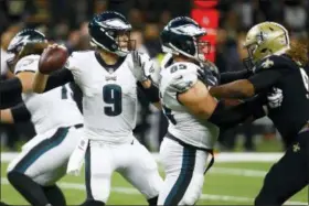  ?? BUTCH DILL — THE ASSOCIATED PRESS ?? Eagles quarterbac­k Nick Foles (9) looks to pass in Sunday’s playoff game against the Saints. Foles has left a legendary legacy that Carson Wentz must now follow.