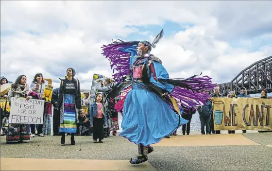  ?? Andrew Rush/Post-Gazette ?? Lydia Green-Miller of Columbus, Ohio, performs what is known as a “fancy shawl dance” during a rally Wednesday to counter the Shale Insight Conference being held at the David L. Lawrence Convention Center. Story on