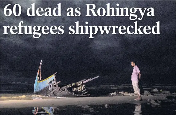  ??  ?? > A destroyed boat is seen on a beach washed up after it sank in rough seas off the coast of Bangladesh, carrying more than 100 people