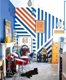  ??  ?? Rufus’ bedroom features a striped feature wall in Deep Space Blue and Slaked Lime by Little Greene Paint Company, and Charlotte’s Locks by Farrow & Ball. ‘It took ages to mask off the stripes, but I’m really pleased with the finished look,’ says Laura