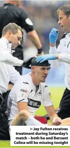  ??  ?? > Jay Fulton receives treatment during Saturday’s match – both he and Bersant Celina will be missing tonight