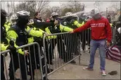  ?? JOHN MINCHILLO — THE ASSOCIATED PRESS ?? Demonstato­rs loyal to President Donald Trump, are sprayed by police Wednesday at the Capitol in Washington.